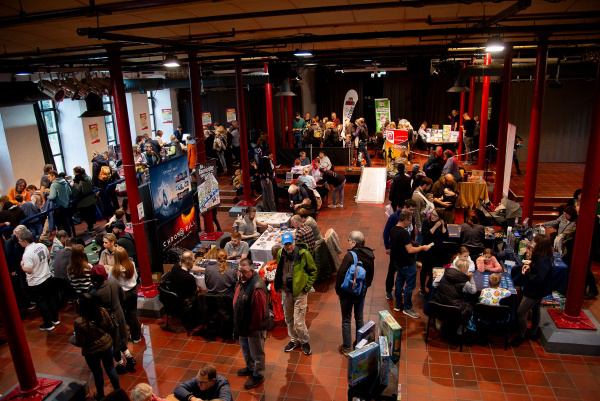ein Blick von der Empore in den Großen Saal, wo Aussteller Besuchern ihre Spiele erklären